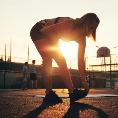 Woman stretching on sports field